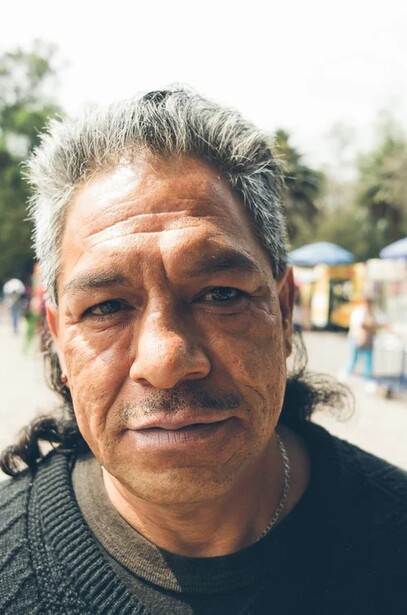 Portrait of a middle-aged man with gray hair outdoors in natural daylight