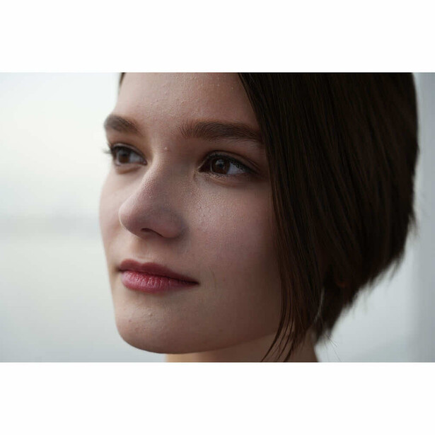 Portrait of a young woman with dark hair in profile, soft natural lighting