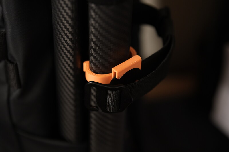 A tripod fastener for backpack side pockets so that the tripod doesn't shake as you move around