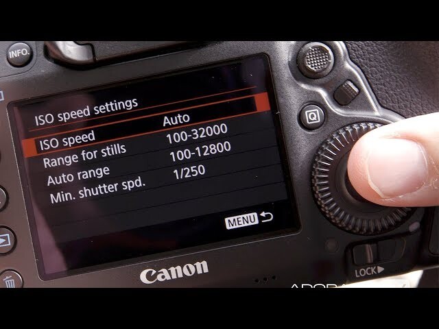 Canon DSLR rear LCD screen displaying ISO speed settings menu with Auto mode selected, showing range 100-32000