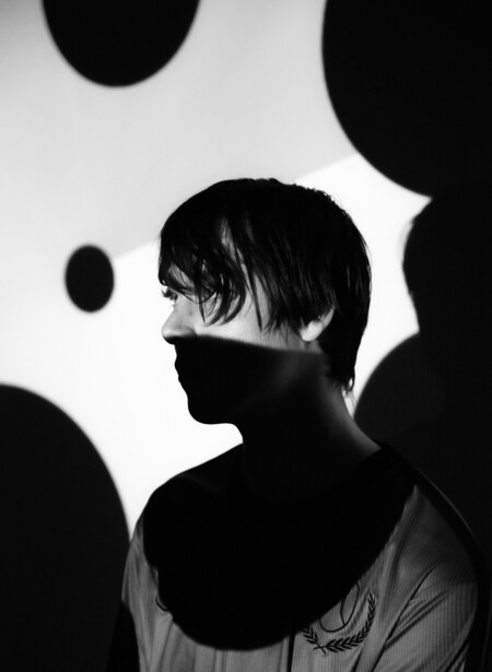 Silhouetted profile of person against geometric black and white circular shapes