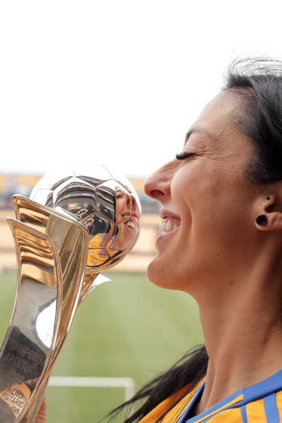 Athlete drinking from a trophy cup during outdoor celebration