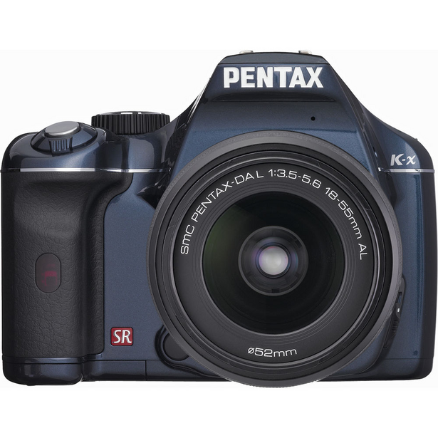 Pentax K-x DSLR camera with 18-55mm kit lens, shown in three-quarter front view against white background