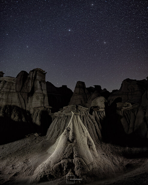 Towering rock formations silhouetted against a starry night sky
