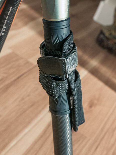 My work-around, using a heavy-duty stretchable elastic strap to tightly secure the Ruggard RTC-10 Timer Case for Tripods.