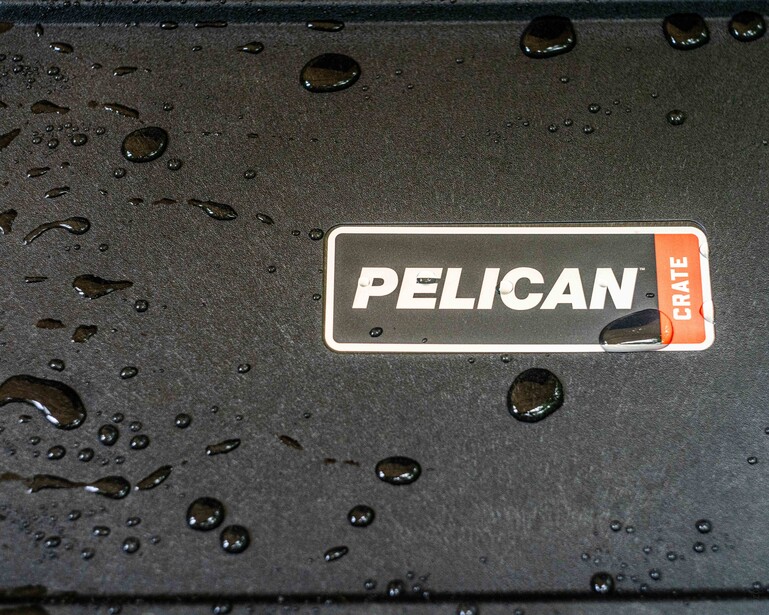 Pelican Elite case with water beads on dark surface