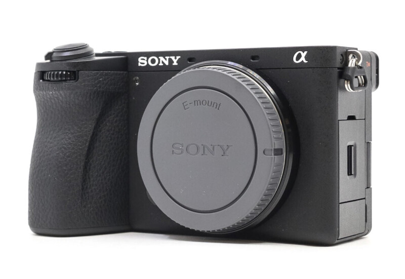 Sony a6400 mirrorless camera body with attached grip, front three-quarter view