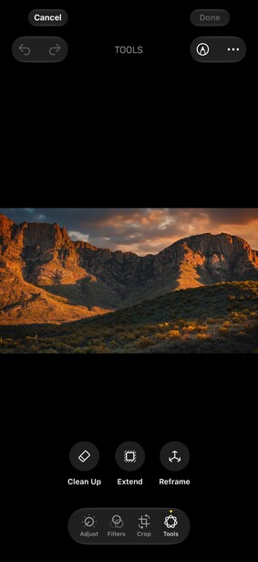 Golden hour landscape of layered desert mountains with warm sunlight illuminating rock formations