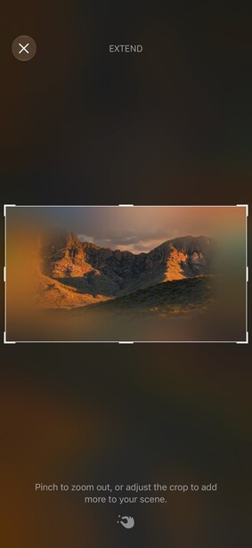 Golden hour landscape with dramatic rocky mountain peaks illuminated by warm sunset light