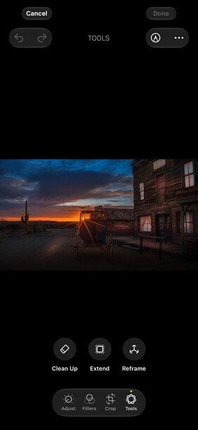 Abandoned truck parked beside a dilapidated building at golden hour sunset