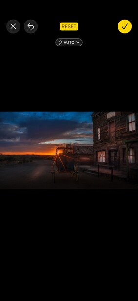 Abandoned truck at dusk with dramatic orange and blue sky
