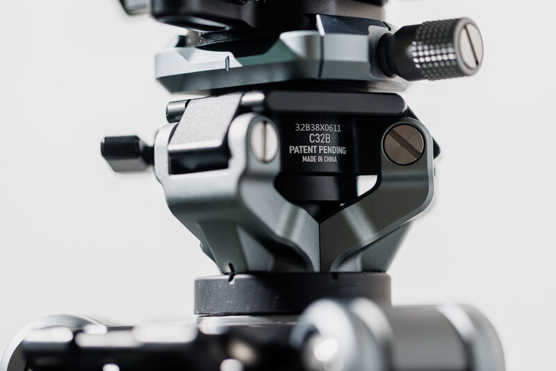 Ball head tripod mount with panoramic capability, showing mechanical controls and patent information