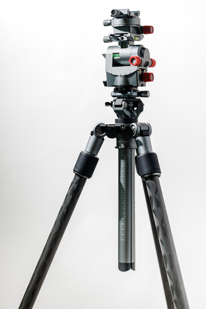 Professional tripod with multi-camera mounting head and red adjustment knobs against white background