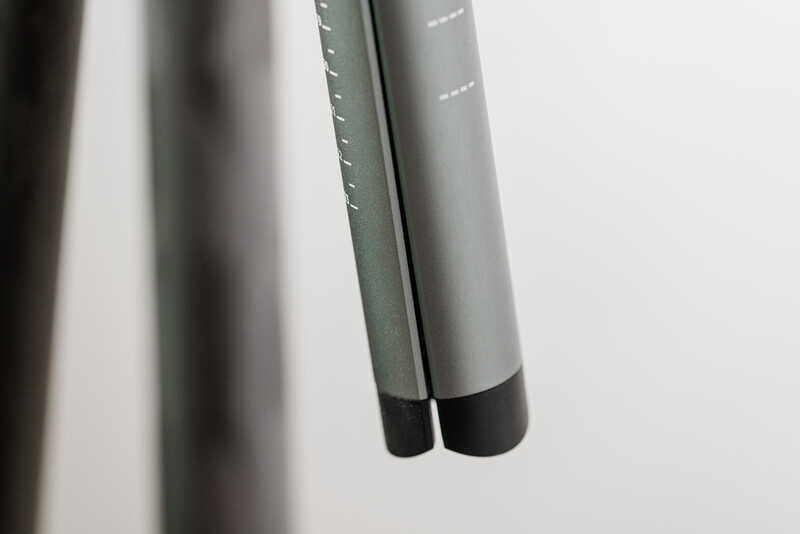 Two gray microphone handles with black foam windscreens positioned vertically against white background