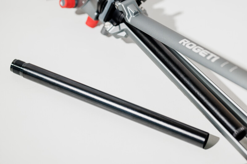Black seatpost and gray bike frame component with red and black adjustment mechanisms against white background