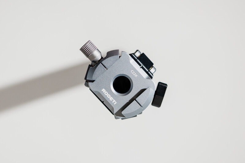 Overhead view of a gray robotic camera head with articulating arms and adjustment knobs