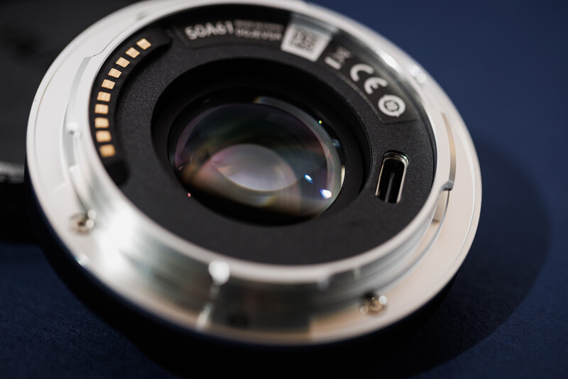 Rear view of a camera lens mount showing electronic contacts and autofocus mechanism