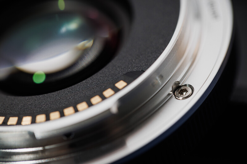 Close-up of camera lens mount showing electronic contacts and metal bayonet connection