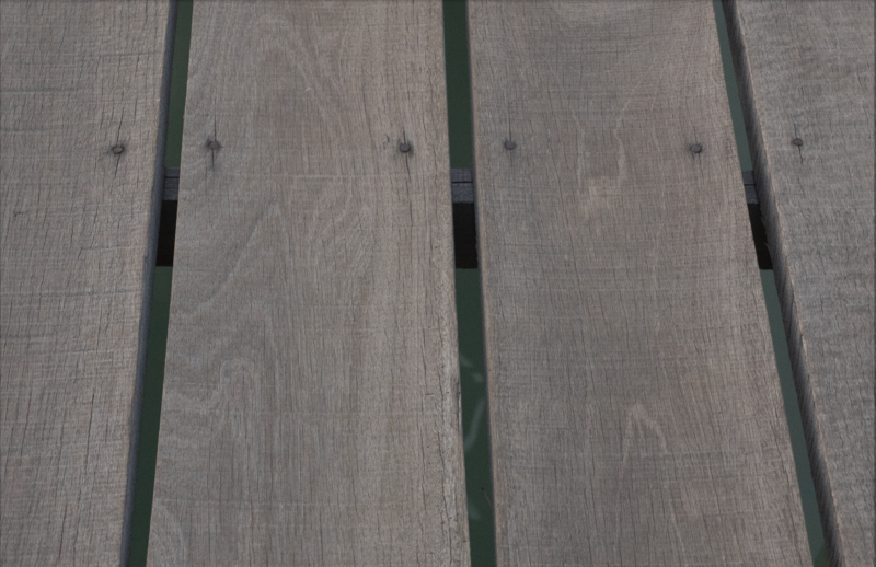 Weathered wooden deck boards with green trim gaps showing wood grain texture