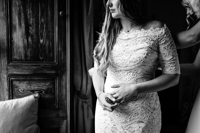 Pregnant woman in lace dress in black and white maternity portrait