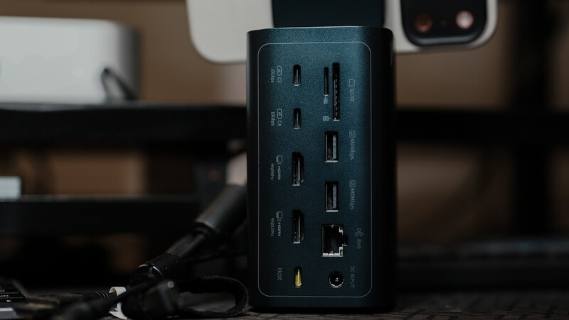 Dark blue multi-port USB hub with multiple USB-C and USB-A ports arranged vertically