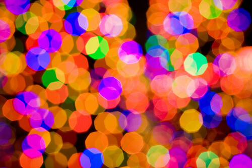 Colorful bokeh lights with out-of-focus circular shapes in vibrant magenta, orange, yellow, blue, and green tones