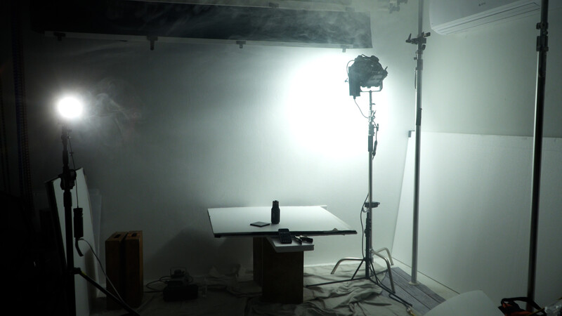 Professional product photography setup with overhead ring light and key light