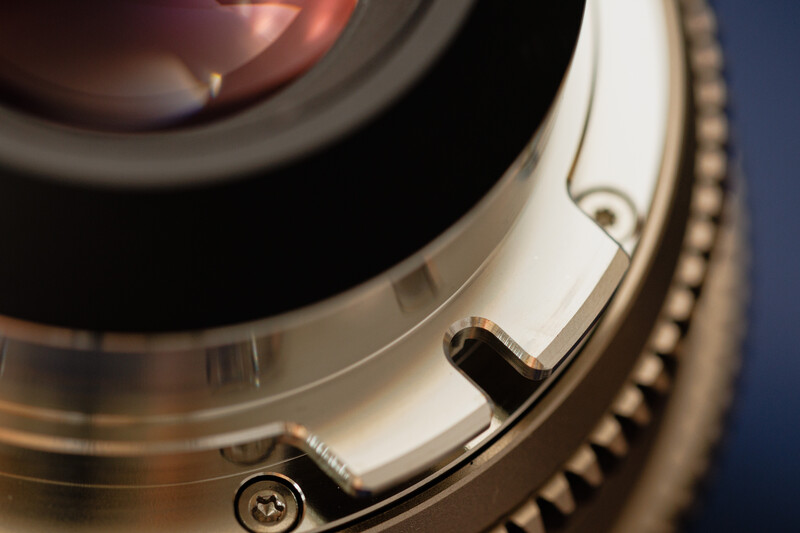 Close-up of camera lens mount showing bayonet mechanism and gear teeth