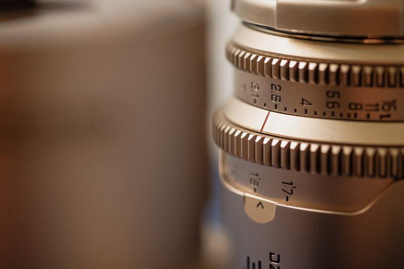 Close-up of vintage lens focusing and aperture rings with depth of field markings