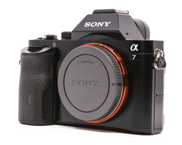 Sony α7 mirrorless camera body with lens cap, front three-quarter view