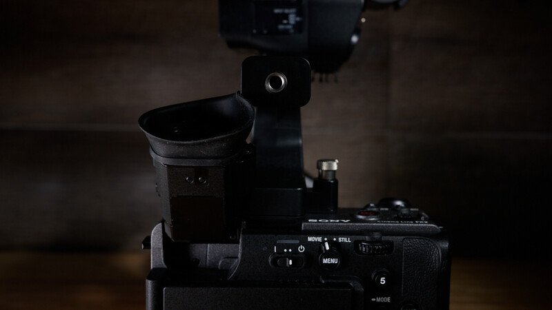 Professional cinema camera with external monitor and microphone mounted on top