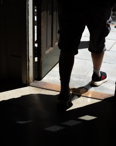 Photo of someone's feet walking out a doorway
