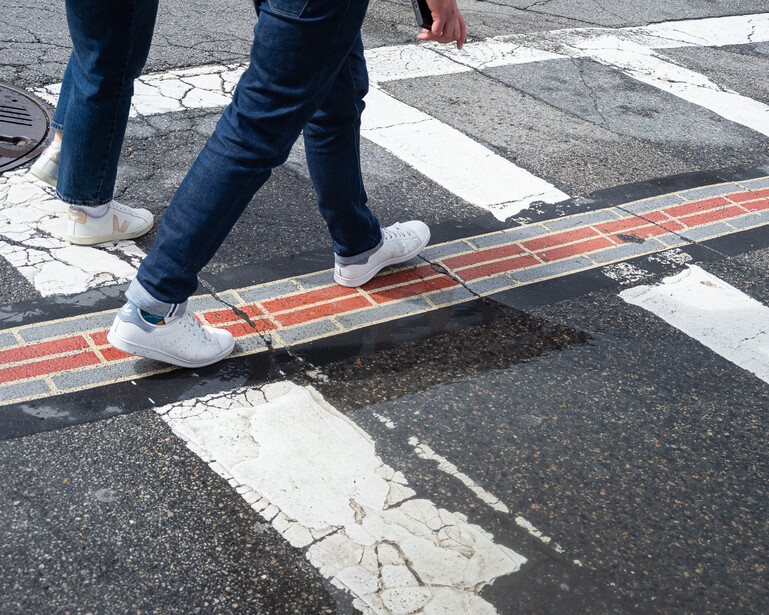 Photo of someone's feet walking on the Freedom Trail in Boston
