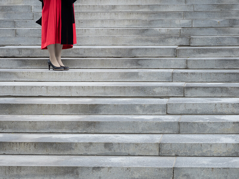 Feet of a graduate standing on stairs at Harvard