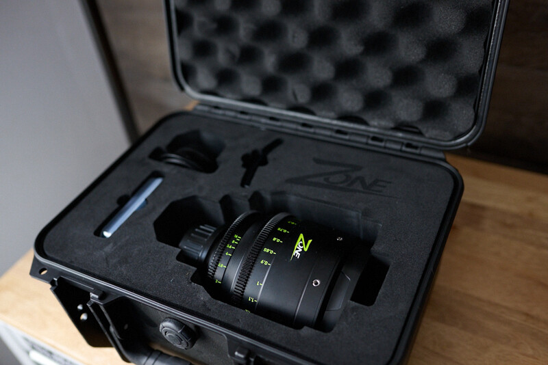 Anamorphic cinema lens in custom foam-fitted hard case with protective foam insert and storage compartments