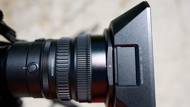Close-up of cinema lens with follow focus system and matte box attachment
