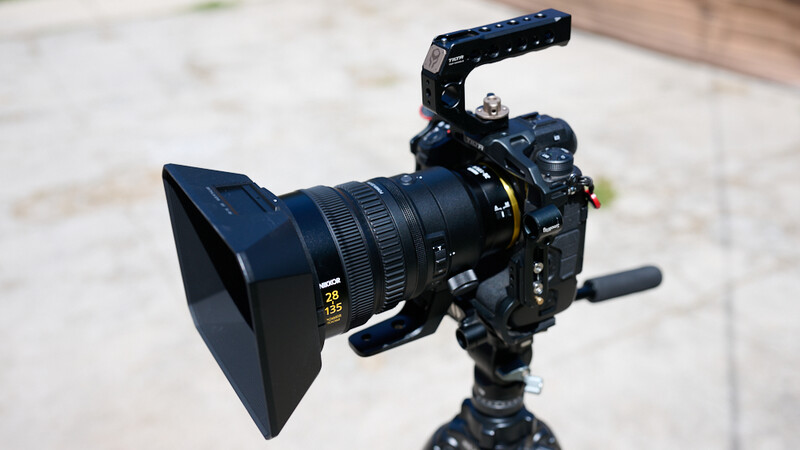 Cinema camera with follow focus system and professional lens mounted on tripod
