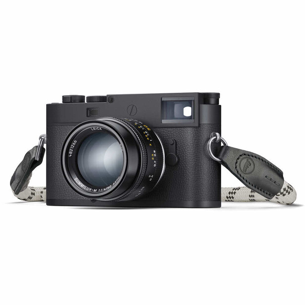 Leica M rangefinder camera with lens and accessories on white background
