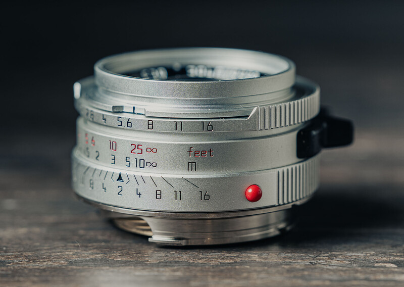 Vintage rangefinder camera lens with distance scale and aperture markings