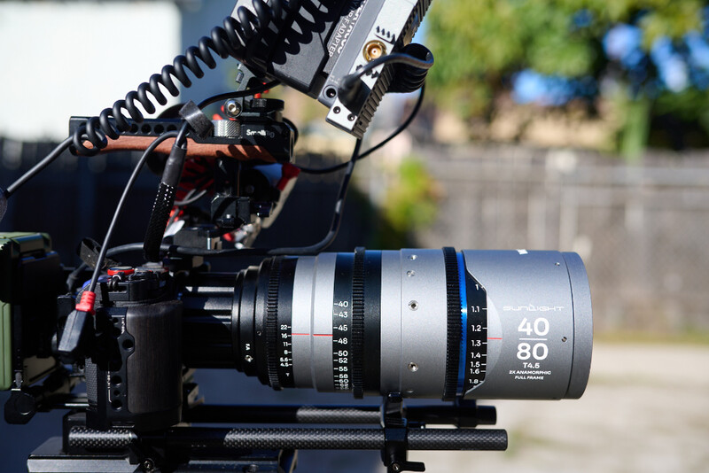 Cinema lens mounted on professional video camera rig with follow focus system
