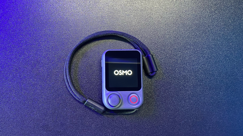 DJI Osmo mobile gimbal with smartphone mounted on gradient purple and blue background