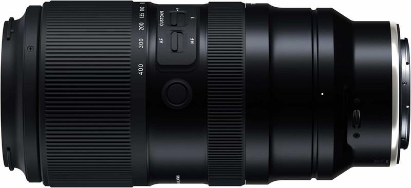 Telephoto zoom lens with focal length markings and manual focus ring displayed against neutral background