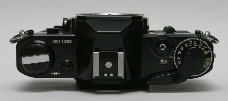 Top-down view of a black film SLR camera body with serial number 2811233, showing twin lens assembly and mechanical controls