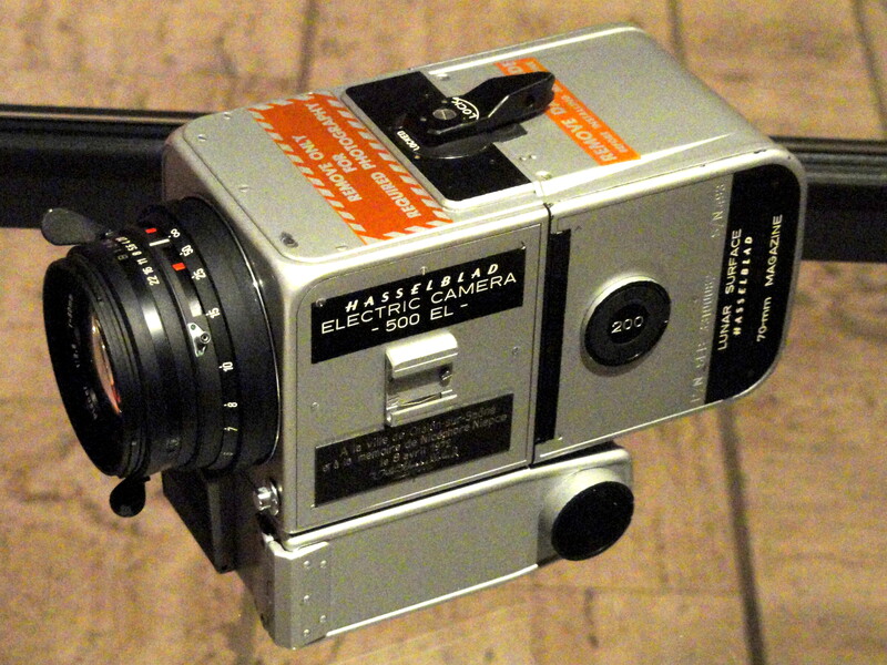 Vintage Mamiya Elektronica 500 RF rangefinder camera with attached lens on wooden surface