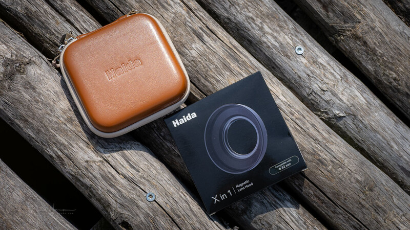 Haida X in 1 filter and brown leather case on weathered wooden surface