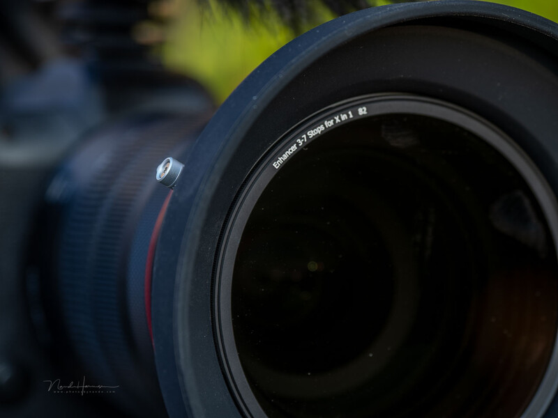 Close-up macro shot of a telephoto lens showing glass elements and depth of field