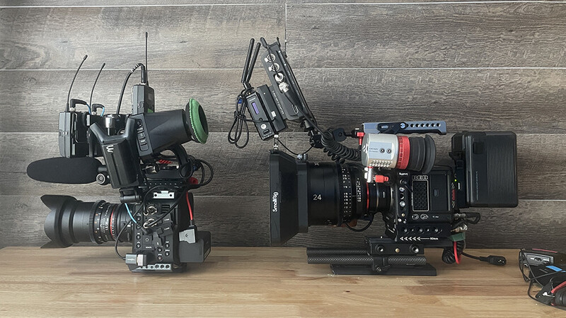 Two professional cinema camera rigs displayed side-by-side on wooden surface