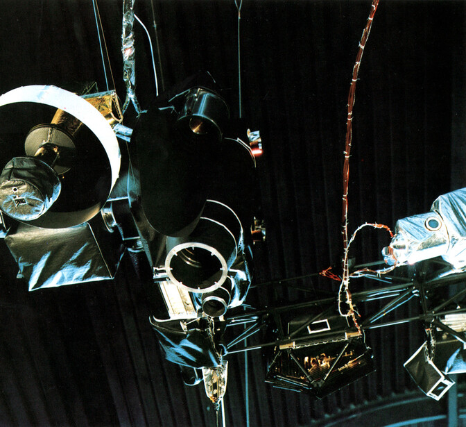 Astronauts performing spacewalk outside spacecraft in Earth orbit