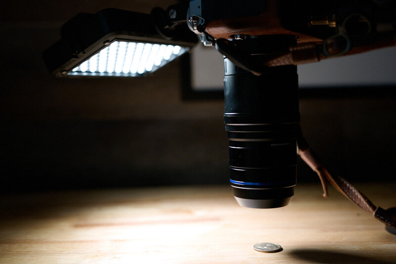 LED panel light and monolight casting bright illumination on wooden surface