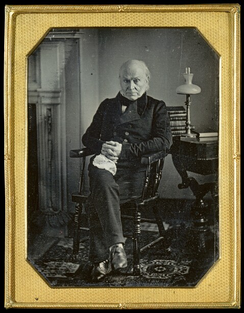 Daguerreotype portrait of elderly man in dark coat seated in chair